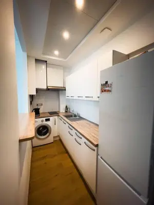 a kitchen with white cabinets and a white refrigerator at Typical Nice neighborhood 15 min from beach in Nice