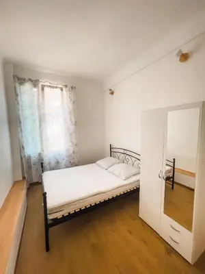 a white bedroom with a bed and a mirror at Typical Nice neighborhood 15 min from beach in Nice