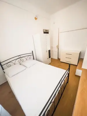 a bedroom with a white bed with a black frame at Typical Nice neighborhood 15 min from beach in Nice
