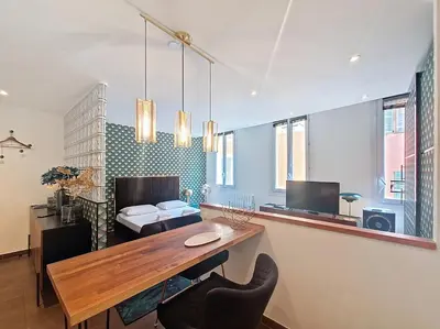 a room with a desk and a bedroom with a bed at Nestor&Jeeves - REFLET DOR - Vieux Nice - Near beach in Nice