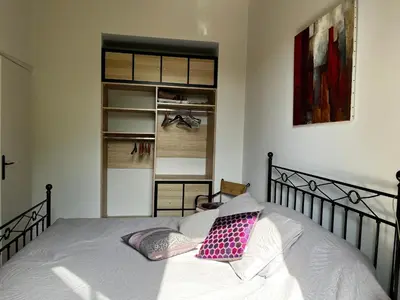 a bed with two pillows on it in a bedroom at Chambre Vue Jardin Alsace Lorraine Victor Hugo in Nice
