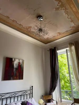 a ceiling with a chandelier on top of a bedroom at Chambre Vue Jardin Alsace Lorraine Victor Hugo in Nice