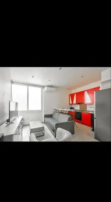 a living room with a couch and a table at Appartement 3 pièces in Nice