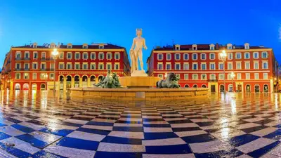 a square with a statue in front of two buildings at Appartement moderne & calme proche mer et centre in Nice