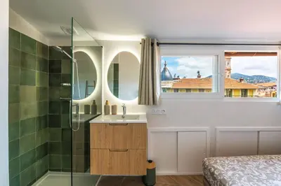 a bathroom with a shower and a sink and a mirror at 12, Boulevard Jean Jaures - Studio in Nice