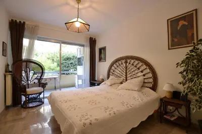 a bedroom with a large bed and a large window at La plus belle vue de Villefranche in Villefranche-sur-Mer