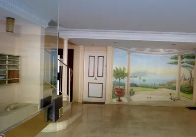 a room with a painting on the wall and a door at La plus belle vue de Villefranche in Villefranche-sur-Mer