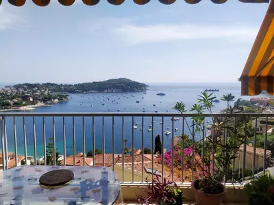 a balcony with a table and a view of the ocean at La plus belle vue de Villefranche in Villefranche-sur-Mer