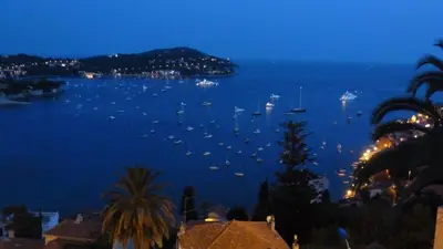 a view of a harbor with boats in the water at night at La plus belle vue de Villefranche in Villefranche-sur-Mer