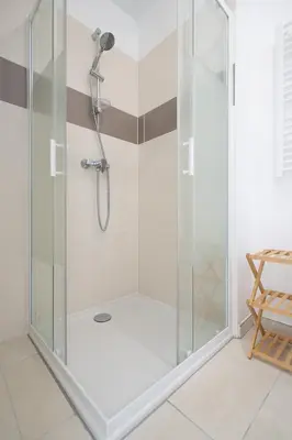 a shower with a glass enclosure in a bathroom at Le Neoroch in Nice
