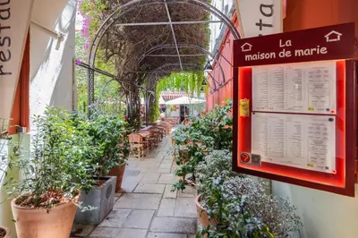 a street with potted plants and a sign on a building at Nice Renting - 5 Massena - Elegant Air-Conditioned Cocoon Quiet Patio Massena in Nice