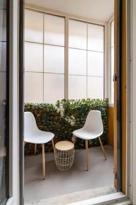 two chairs and a table in front of a window at Nice Renting - 5 Massena - Elegant Air-Conditioned Cocoon Quiet Patio Massena in Nice