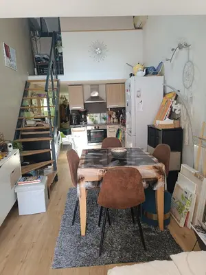 a kitchen with a table and chairs in a room at Maison hauteur Nice in Nice