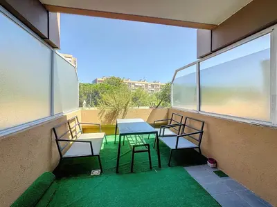 a balcony with two chairs and a table and a window at Le Bella Vita in Nice