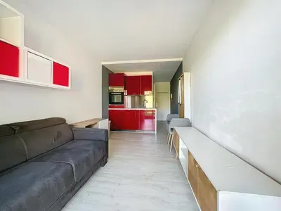 a living room with a couch and a kitchen at Le Bella Vita in Nice