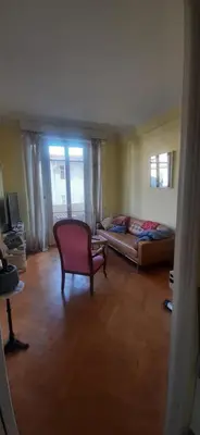 a living room with a couch and a chair at Palais Clemenceau in Nice