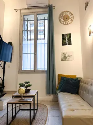 a living room with a couch and a window at AngeVert HolidayHouse in Nice