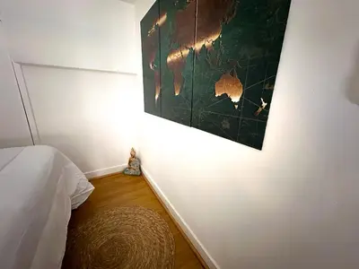 a bedroom with a bed and a painting on the wall at AngeVert HolidayHouse in Nice