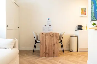 a room with a table with a bottle of water on top at L'Escale Niçoise in Nice