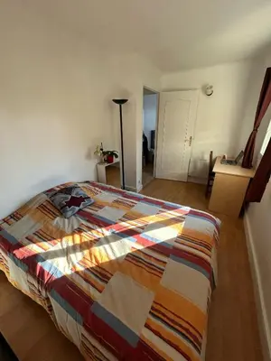 a living room with a couch and a table at Cosy appartement en plein centre-ville dans un halo de verdure avec vue mer in Nice
