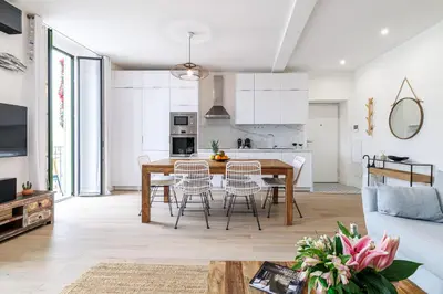a kitchen and dining room with a table and chairs at Sunlight Properties - Archibald - Nice Port area, 2 Bedrooms, stunning holiday rental apartment with balcony & parking in Nice