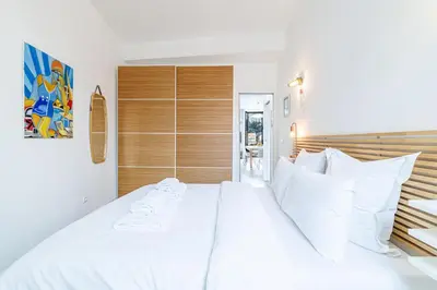 a bedroom with a large white bed with white pillows at Sunlight Properties - Archibald - Nice Port area, 2 Bedrooms, stunning holiday rental apartment with balcony & parking in Nice