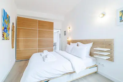a bedroom with a large white bed with white pillows at Sunlight Properties - Archibald - Nice Port area, 2 Bedrooms, stunning holiday rental apartment with balcony & parking in Nice