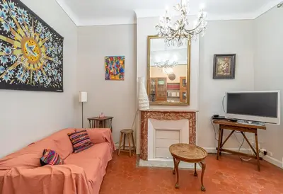 a living room with a couch and a television at Suite Bottero in Nice