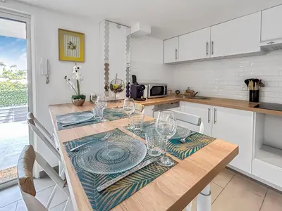 a kitchen with a table with wine glasses on it at Havre de paix avec terrasse in La Gaude