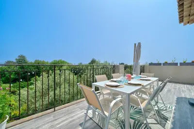 a white table and chairs on a balcony at Maison niçoise vue dégagée avec jacuzzi privatif in Nice