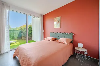 a bedroom with a bed and a large window at Maison niçoise vue dégagée avec jacuzzi privatif in Nice