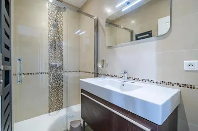 a white bathroom with a sink and a shower at Maison niçoise vue dégagée avec jacuzzi privatif in Nice