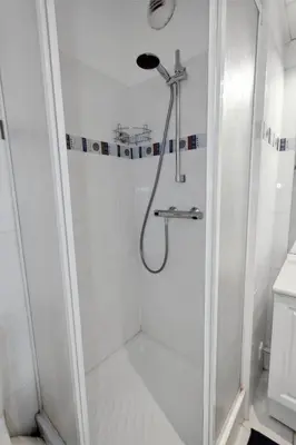a white hallway with a sliding door at L'Azur - Seaview - AC - Tram - WIFI - Airport in Nice