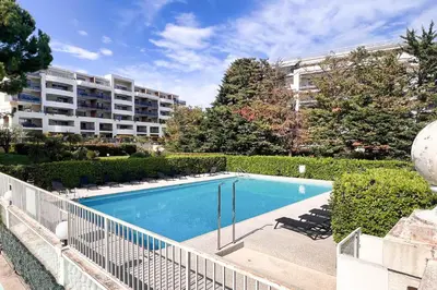 a swimming pool in front of a apartment building at Sandaya - 10min à pied de la Plage in Cagnes-sur-Mer
