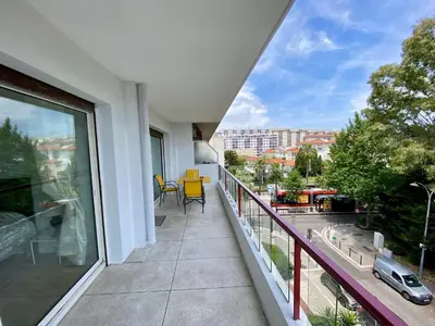 a hallway with a table and a mirror on a wall at Nice West Pretty one bedroom in Nice