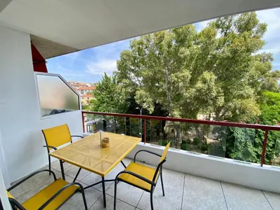 a table and chairs on a balcony with a view at Nice West Pretty one bedroom in Nice