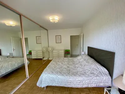 a bedroom with two beds and a large mirror at Nice West Pretty one bedroom in Nice