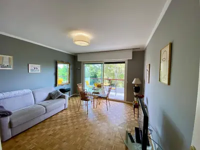 a living room with a couch and a table at Nice West Pretty one bedroom in Nice