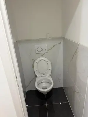a small bathroom with a toilet in a stall at Big Apartement 20 min from beach in Nice