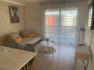 a living room with a couch and a table at Sun appart in Nice