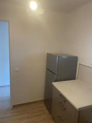 a kitchen with a stainless steel refrigerator and a counter at Sun appart in Nice