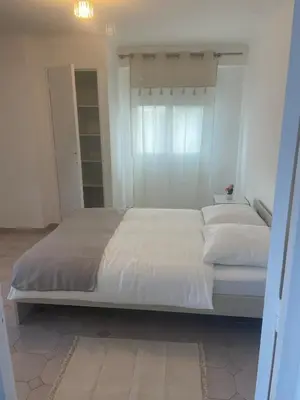 a large white bed in a white bedroom at Sun appart in Nice
