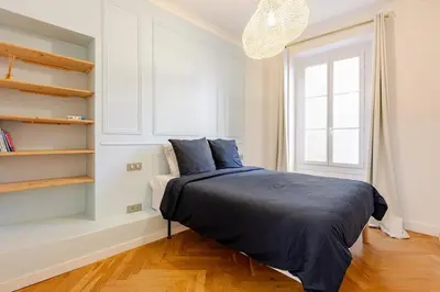 a bedroom with a bed with blue sheets and a window at Bella Nissa Bnb - AC wifi - cosy - 2 bedrooms in Nice