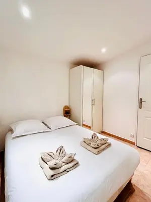 a bedroom with a white bed with towels on it at Riviera Mornings - Old Town Stay - 5 Min to Beach & Breakfast in Villefranche-sur-Mer