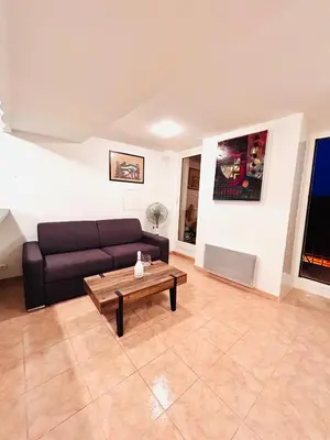 a living room with a couch and a coffee table at Riviera Mornings - Old Town Stay - 5 Min to Beach & Breakfast in Villefranche-sur-Mer