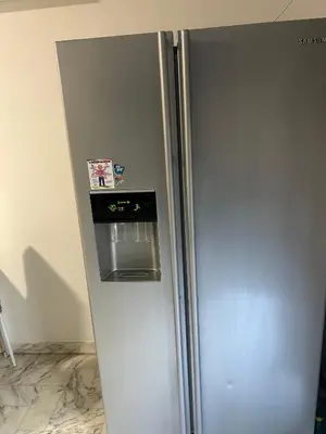 a refrigerator in a kitchen with a picture on it at Deux pièces au centre-ville proche des plages et centres commerciaux in Saint-Laurent-du-Var