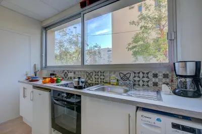a kitchen with a sink and a window at Castel du Port - Happy Rentals in Saint-Laurent-du-Var