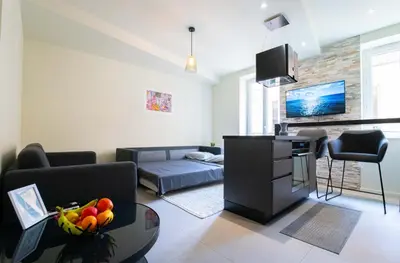 a living room with a couch and a table at Spacieux et Moderne T2 - Hyper Centre in Nice