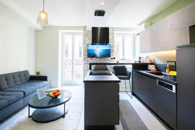 a kitchen and living room with a couch and a table at Spacieux et Moderne T2 - Hyper Centre in Nice