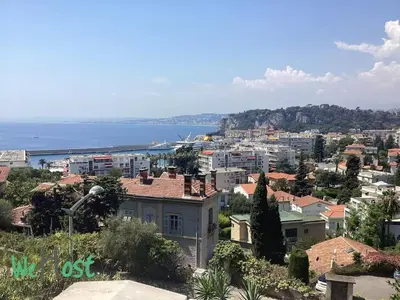 a group of rocks in the water with mountains at WeHost Carnot - Bail Mobilité ONLY - Escapade côté Port pour 2 in Nice